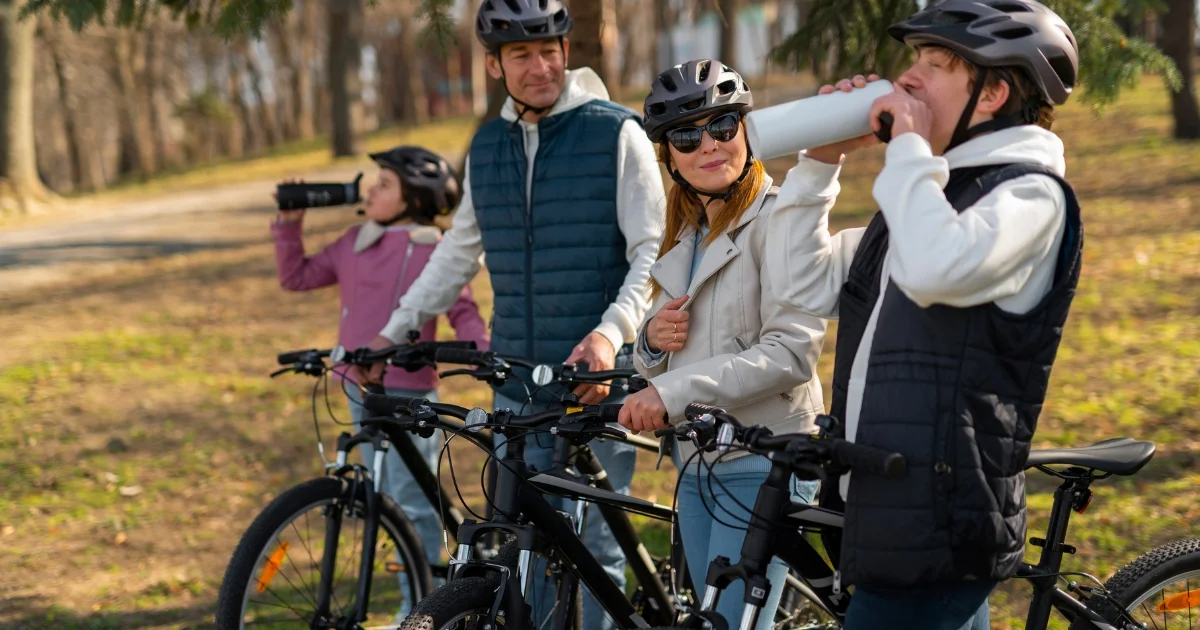 family of four on a bike ride spotted for a water break 